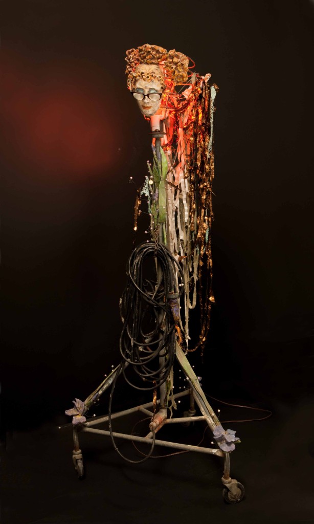 Iris is an assemblage with clay and found objects by Leslie Ann McQuaide
